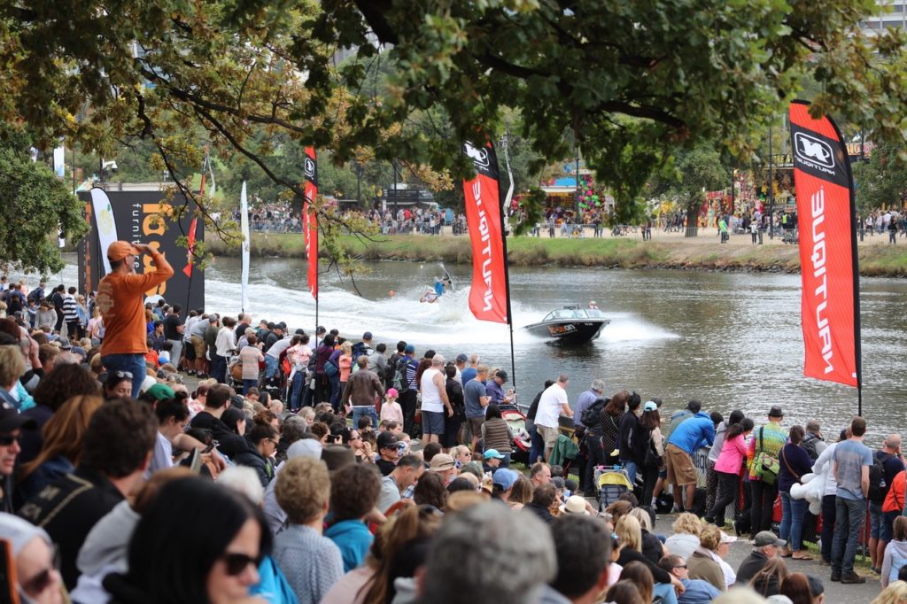 A packed crowd on the banks of the Yarra River watches the Moomba Masters