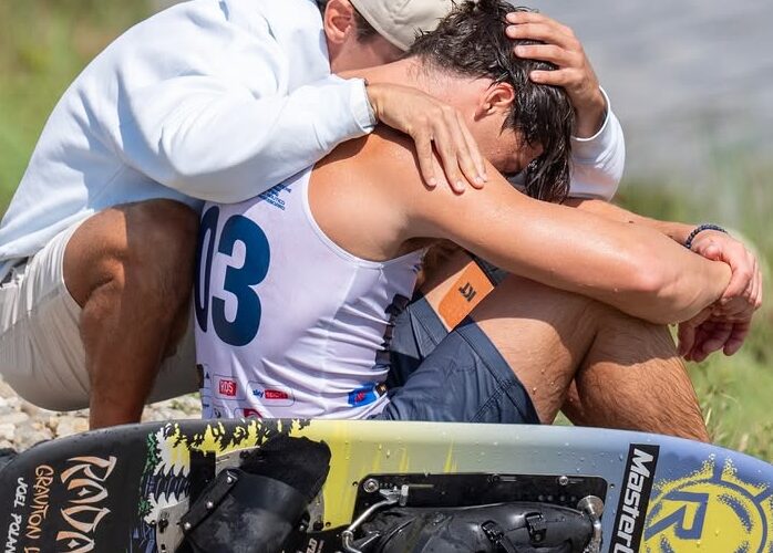 Joel Poland of Great Britain is consoled by friend Edoardo Marenzi of Italy after Poland fell early in his trick run during the 2025 IWWF World Waterski Championships at Parco Nautico del Sesia in Novara, Italy.